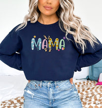 a woman wearing a sweatshirt that says mama