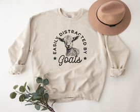 a sweatshirt with a goat on it and a hat