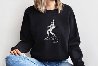 a woman wearing a black sweatshirt with a picture of a man on it