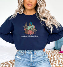 a woman wearing a sweatshirt that says it's past my bedtime