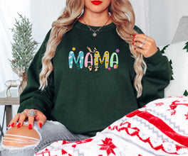 a woman sitting on a bed wearing a green sweatshirt