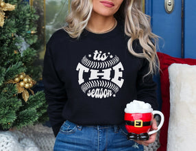 a woman holding a cup of coffee next to a christmas tree