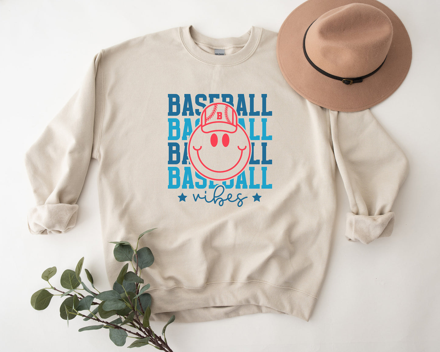 a baseball sweatshirt with a hat on top of it