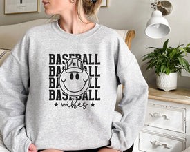 a woman sitting on a couch wearing a baseball sweatshirt