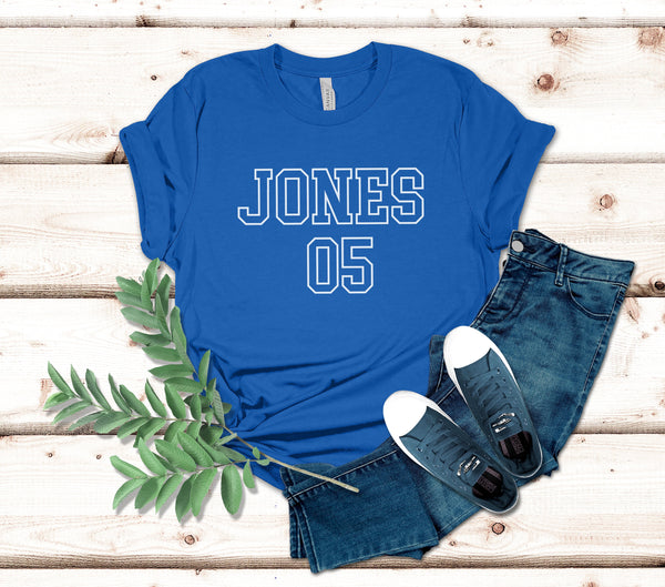 a t - shirt that says jones on it next to a pair of jeans