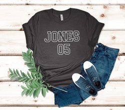 a t - shirt that says jones on it next to a pair of jeans